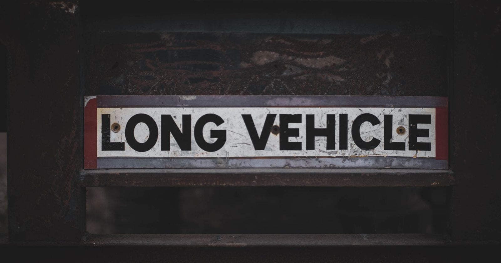 A low rail bridge in Melbourne had been getting hit by trucks for years, so authorities installed flashing height warnings and heavy protection beams in front of it; drivers still sometimes hit the beams or bridge despite the warnings