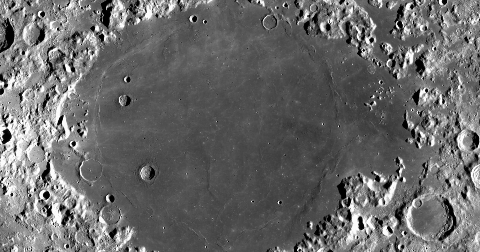 Mare Crisium seen from lunar orbit, a dark smooth basin ringed by bright cratered highlands