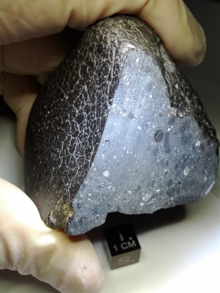Garnet had never been confirmed in a Martian meteorite until researchers examining NWA 8171 at the Royal Ontario Museum found andradite inside a fragment smaller than one millimetre. Some surrounding minerals carry Martian chemistry, but scientists cannot yet tell whether it records an unknown magma, ancient fluid alteration, metamorphism—or debris from an asteroid that struck Mars.