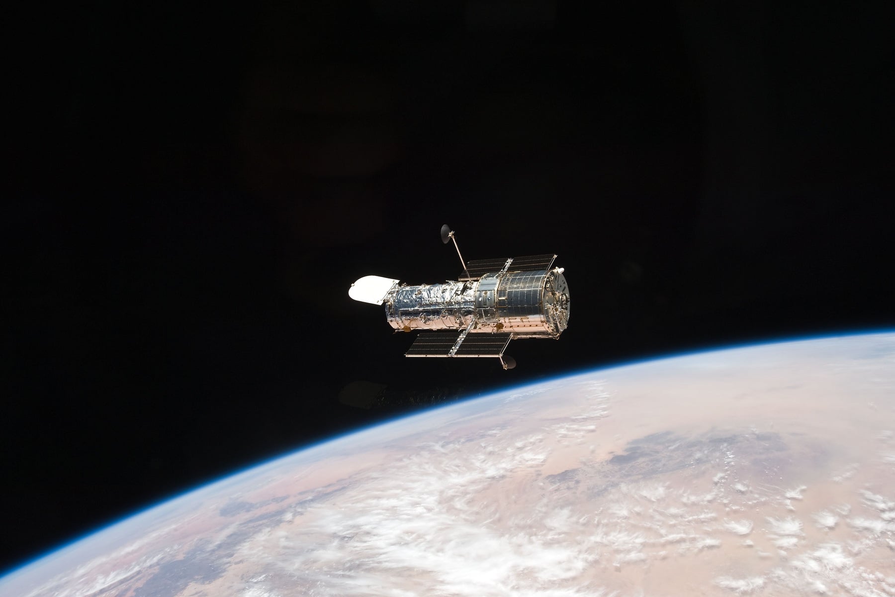 NASA's Hubble Space Telescope floating above Earth's curved horizon after STS-125