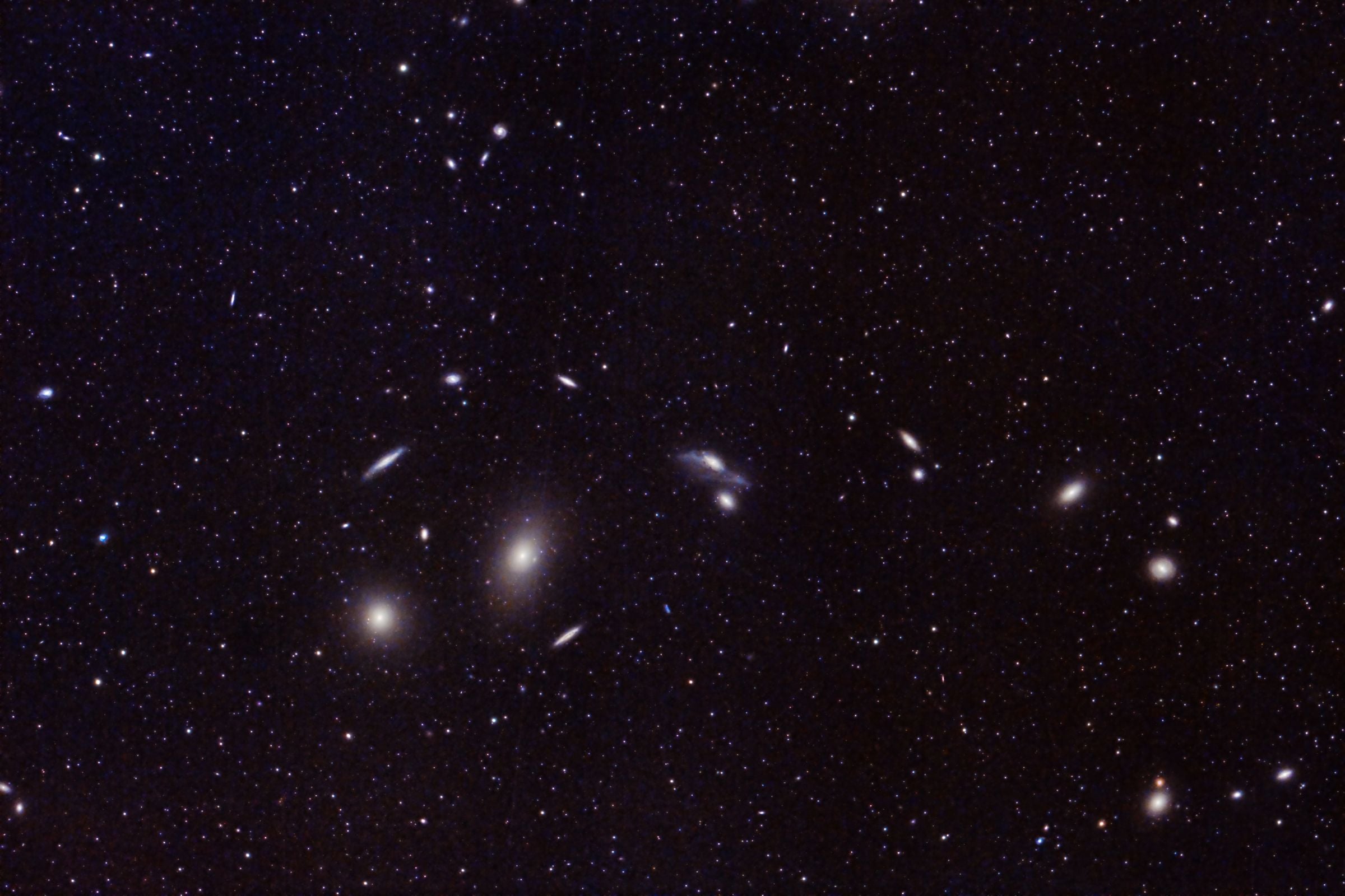 Deep-sky field containing numerous distant galaxies and stars