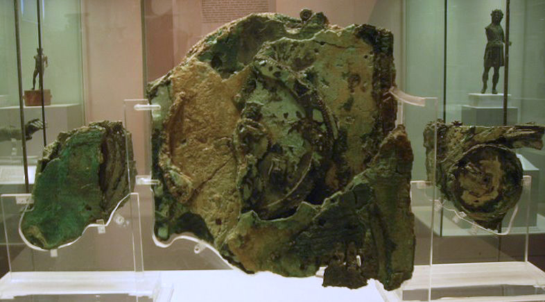 Three corroded bronze fragments of the Antikythera Mechanism